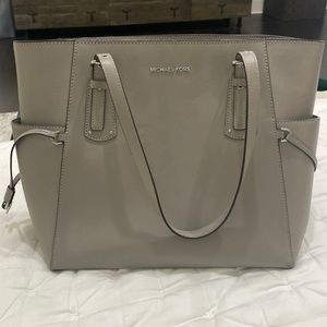 Michael Kors light grey purse. 11 inch tall, 15 inch wide. Good condition
